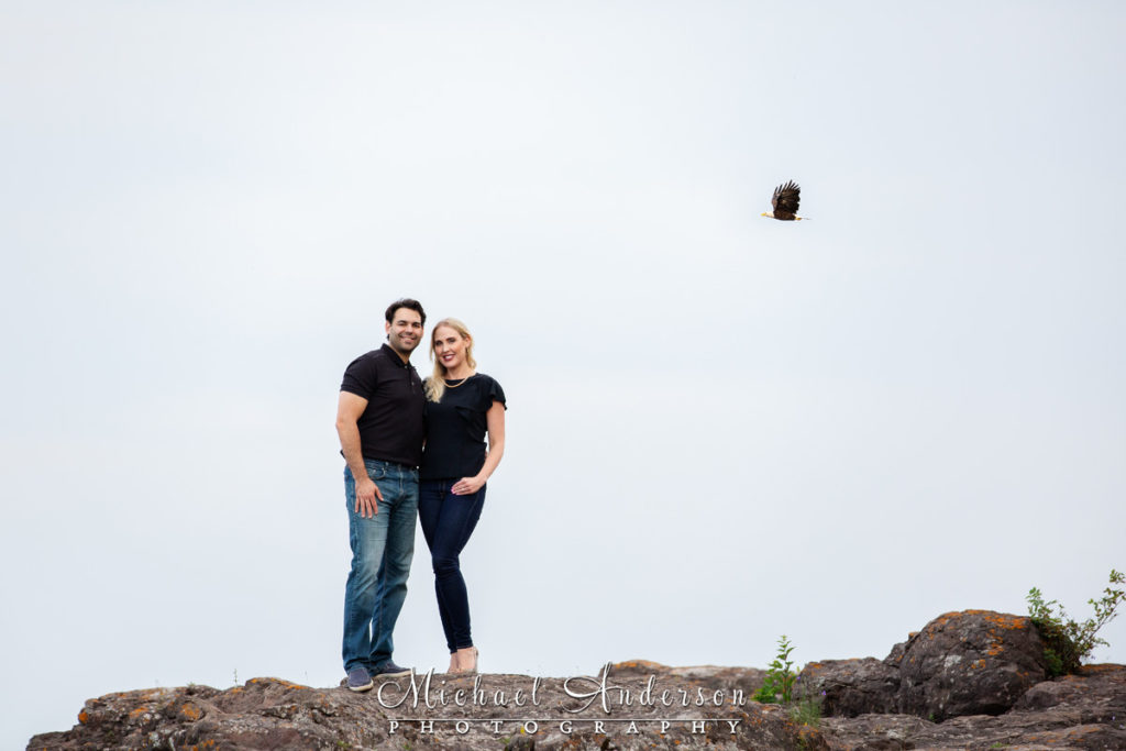 Lake-Superior-engagement-pictures-Ionas-Beach-bald-eagle-flying-by