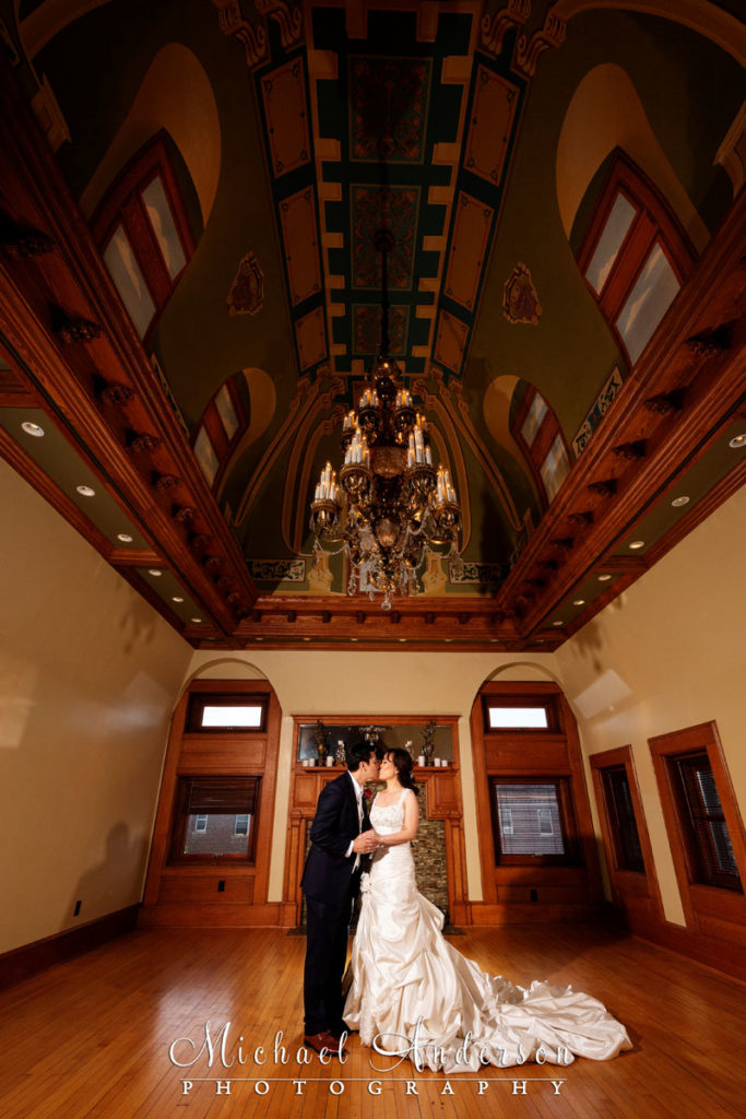 The Van Dusen Mansion wedding reception photos of the bride and groom kissing in the Third Floor Gallery.