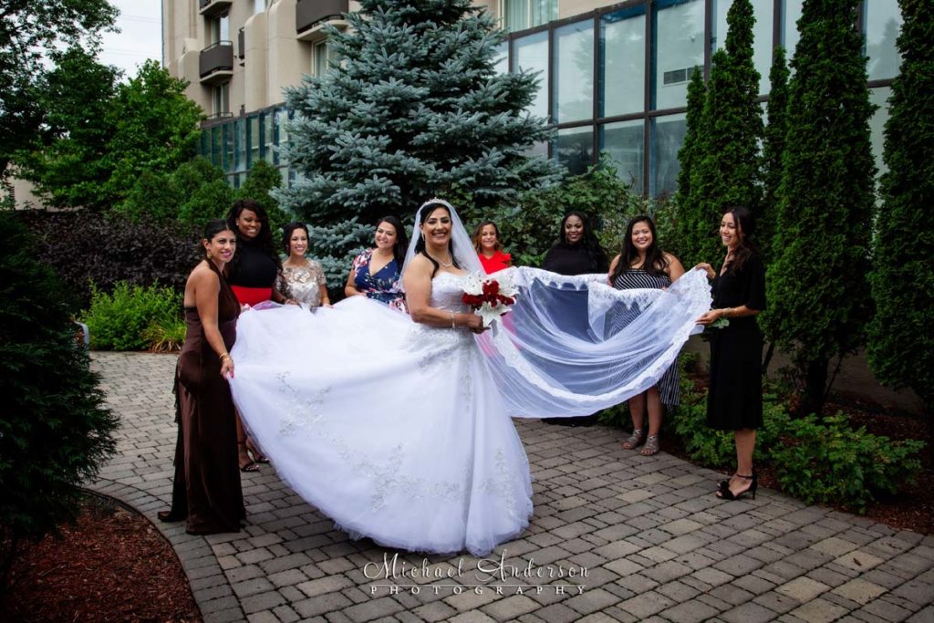 Bride and her bridesmaids in the outdoor courtyard at the Embassy Suites Minneapolis Airport.