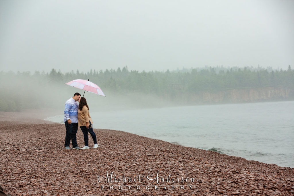 North Shore engagement photos in the rain at Iona's Beach on Lake Superior.