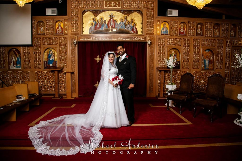 Formal Saint Mary's Coptic Orthodox Church wedding photograph of the bride and groom at the altar.