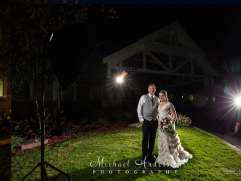 Bride and groom in front of the clubhouse at the TPC Twin Cities. Photo was taken before their light painted wedding photograph began.