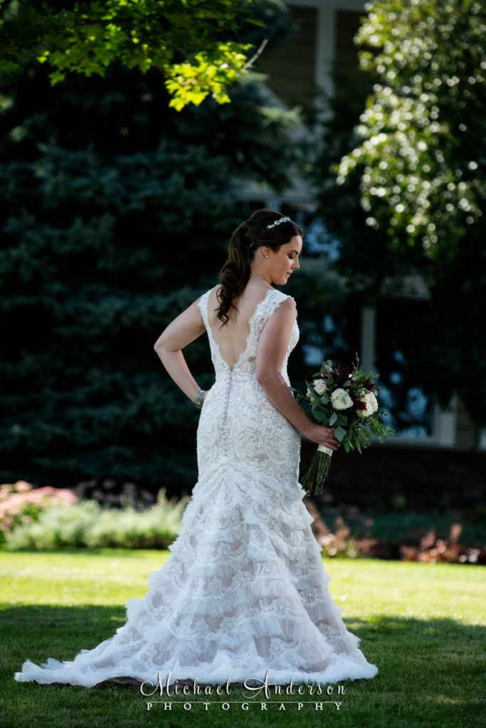Outdoor TPC Twin Cities wedding photographs of the back of the brides beautiful wedding gown.