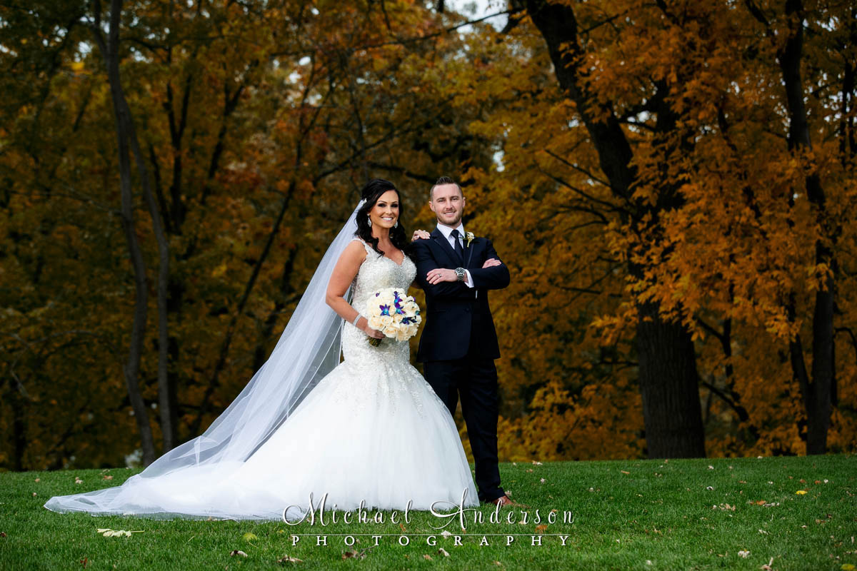 Full length Leopold's Mississippi Gardens wedding photos of the bride and groom in the fall colors.