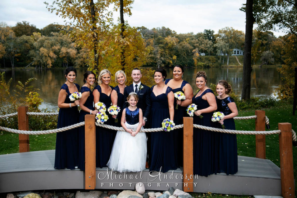 Leopold's Mississippi Gardens wedding photos of the groom, bridesmaids, and flower girl on a cute bridge.