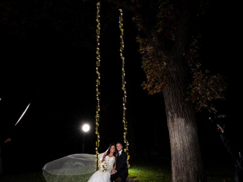 The starting image of the bride and groom on a swing before creating the couple's Mississippi Gardens wedding light painting.