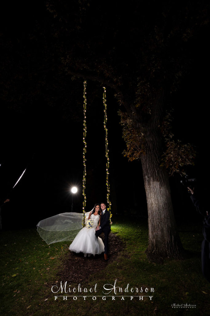 The starting image of the bride and groom on a swing before creating the couple's Mississippi Gardens wedding light painting.