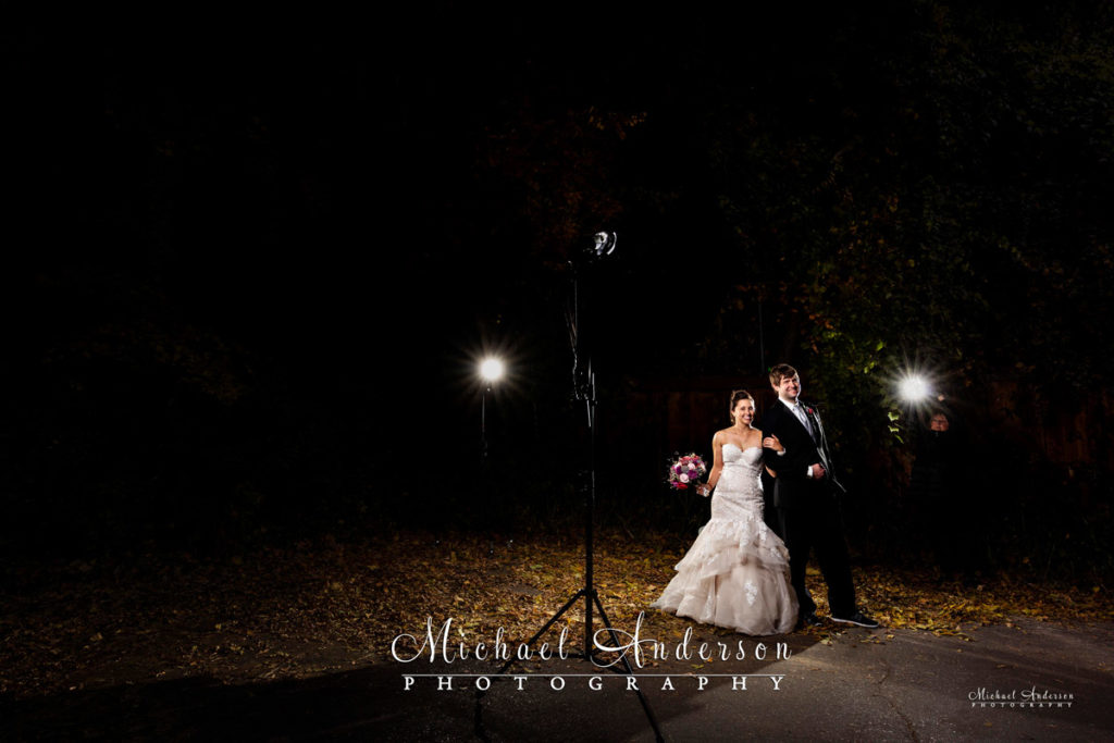 The bride and groom pose for their fall color light painted wedding photograph.