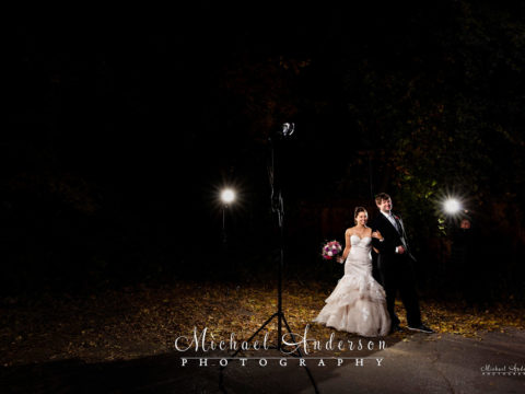 The bride and groom pose for their fall color light painted wedding photograph.