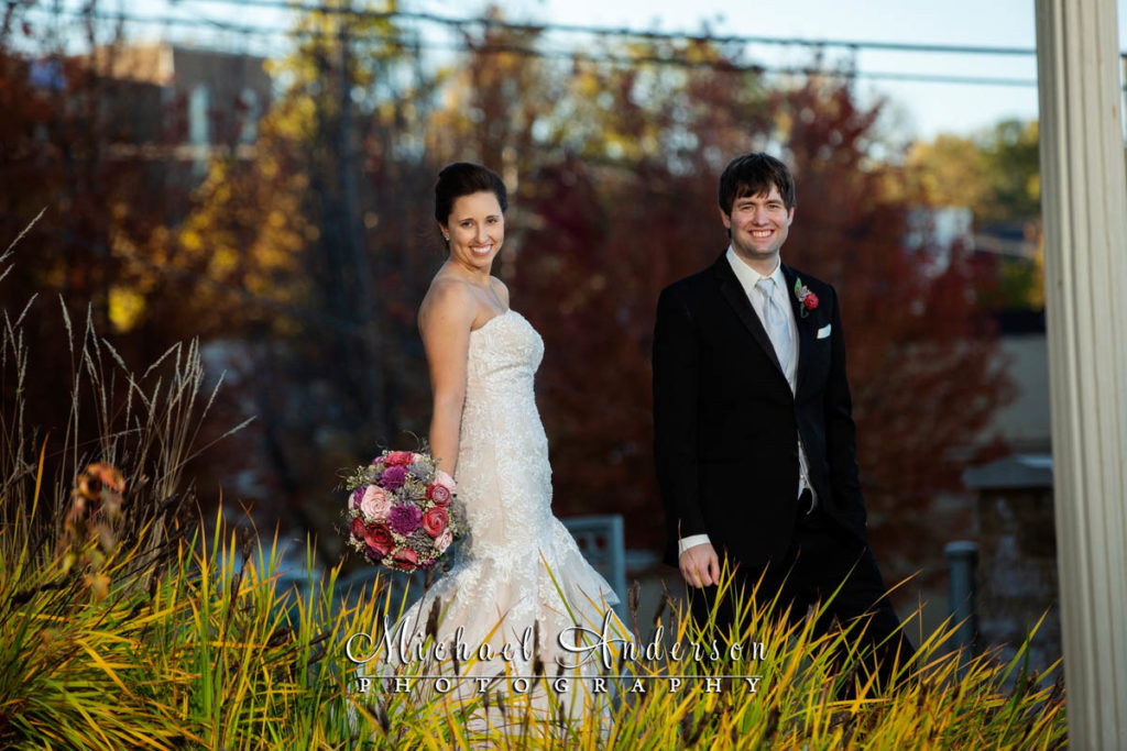 A bride and groom in the fall colors at Teddy Bear Park in Stillwater, MN.