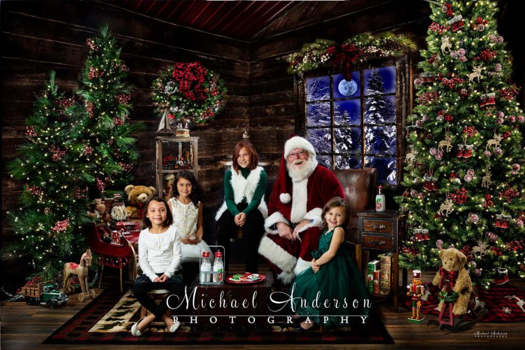 Four sisters meet Santa Claus and poses for a picture with them too!