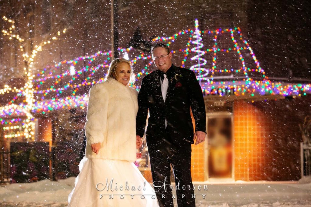 The 3 Ten Event Venue wedding reception photos of the bride and groom in a snowstorm.