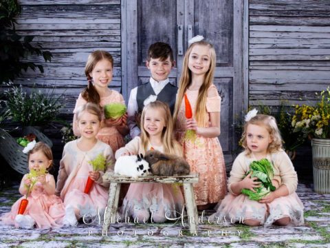 Seven cousins pose with bunnies during their 2019 Easter photos with real bunnies.
