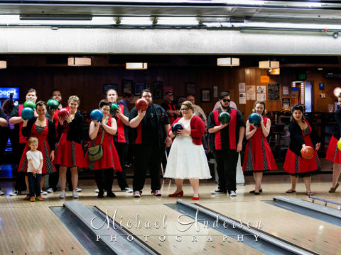 A fun photo of a large wedding party on the bowling lanes at Elsie's.