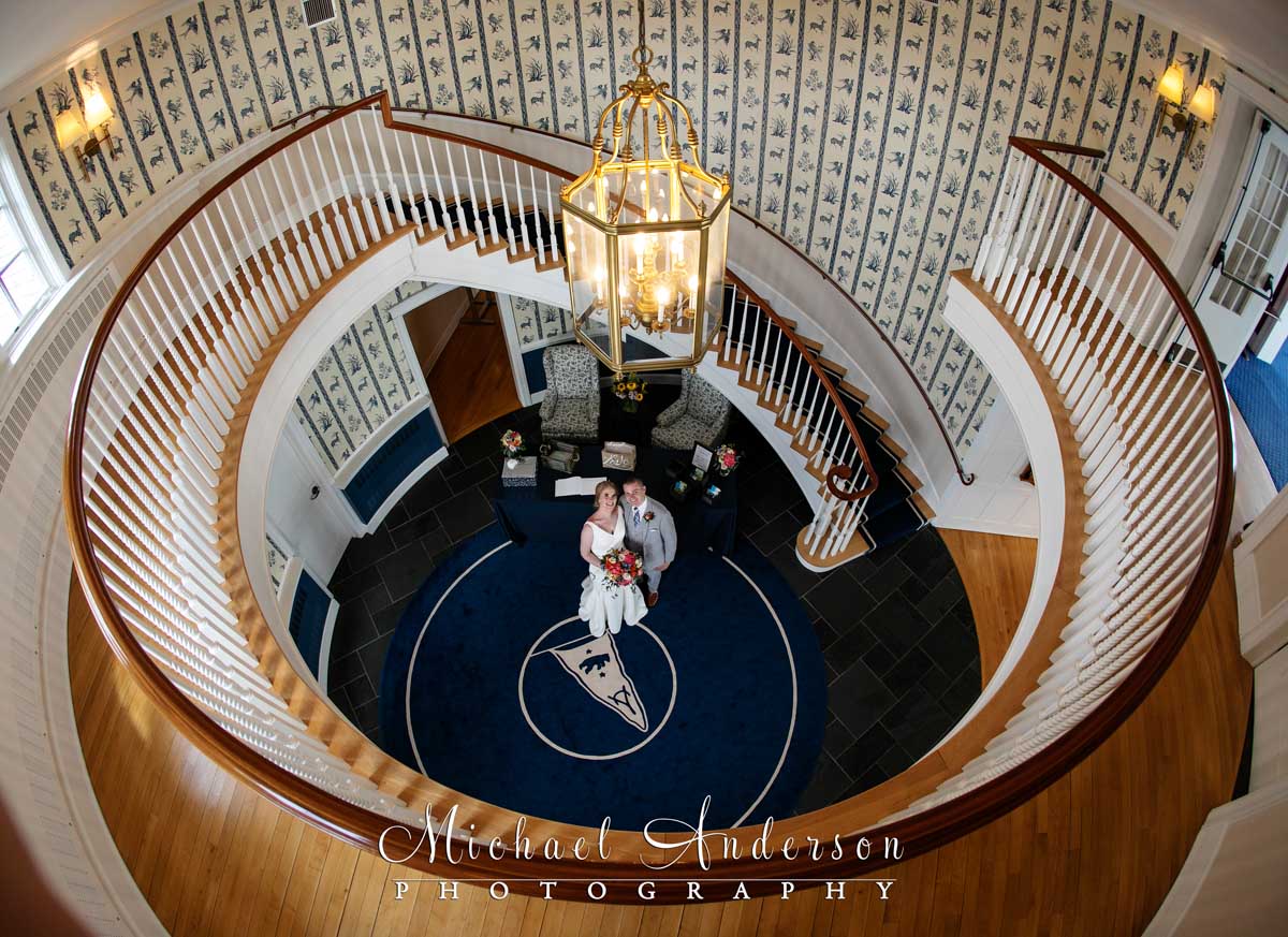 The bride and groom on the circular Grand Staircase at their White Bear Yacht Club wedding on White Bear Lake.