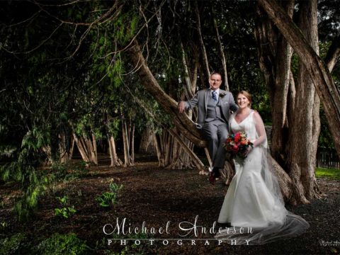 A beautiful White Bear Yacht Club light painting of the bride and groom in the cedar trees.