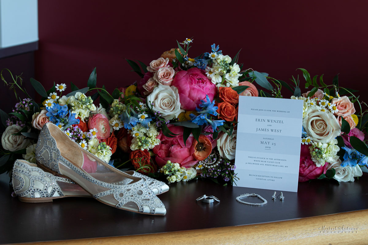 Wedding rings, invitation, bouquet, and the bride's shoes before light painting them.