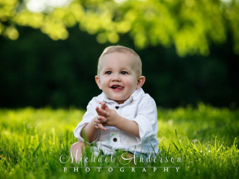 Easton is one-year-old! His portrait in a grassy field.