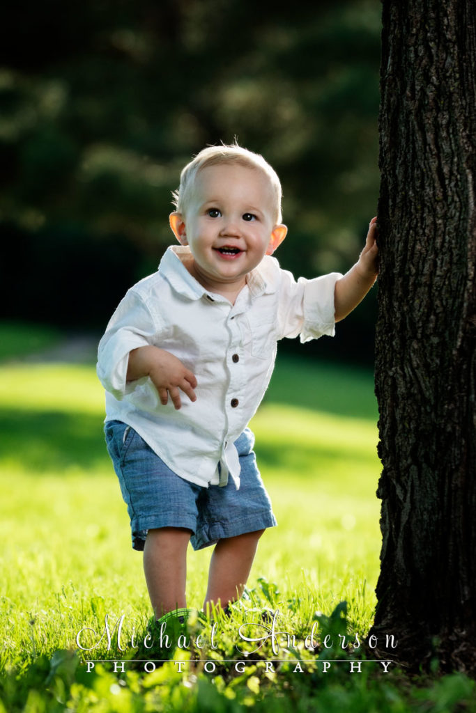 Easton is one-year-old! His portrait staring next to a tree.
