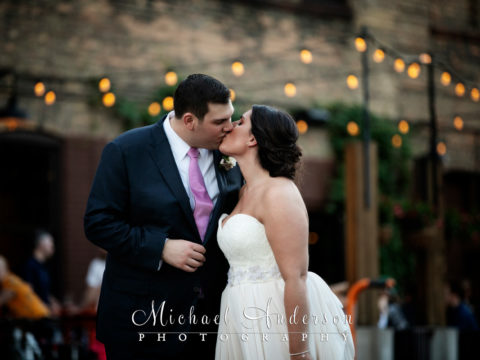 A pretty twilight photograph of the bride and groom outside during their Solar Arts Building wedding reception.