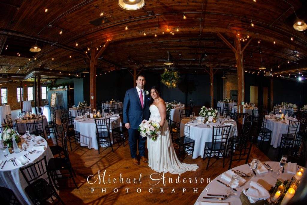 Bride and groom in the middle of their pretty ballroom at their Solar Arts Building wedding reception.