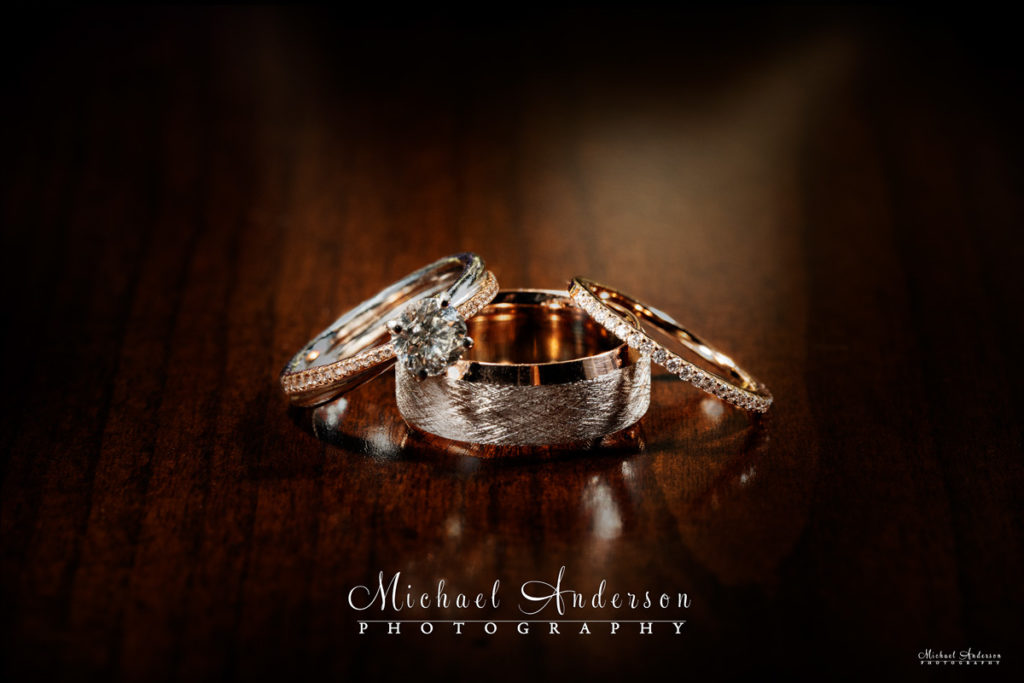 A pretty light painted close-up photograph of the bride and grooms wedding rings.