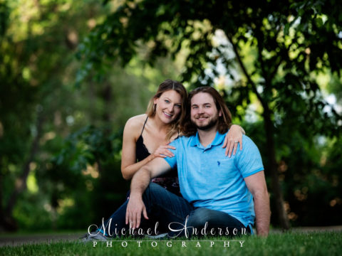 Saint Anthony Main engagement photography of a cute couple sitting in the grass.