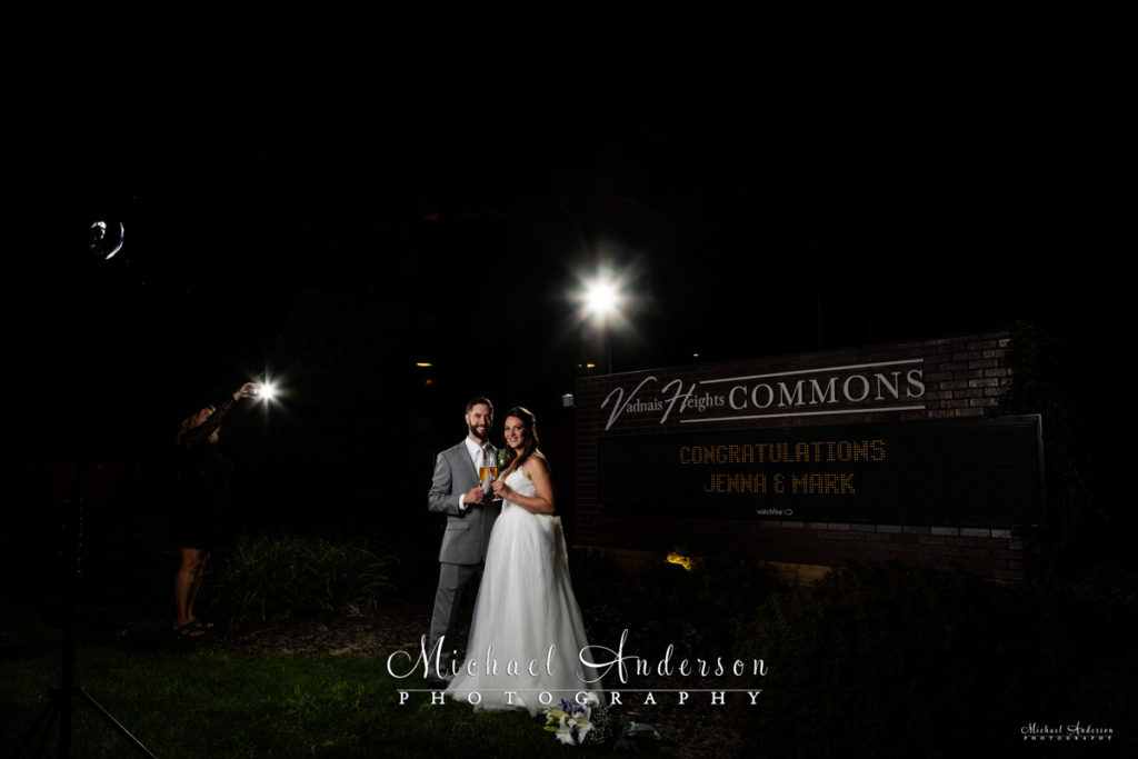 The bride and groom pose for their Vadnais Heights Commons light painting.