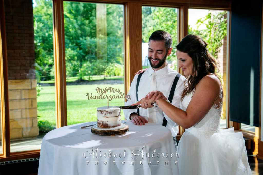 Vadnais Heights Commons wedding photos of a cute couple cutting their wedding cake.