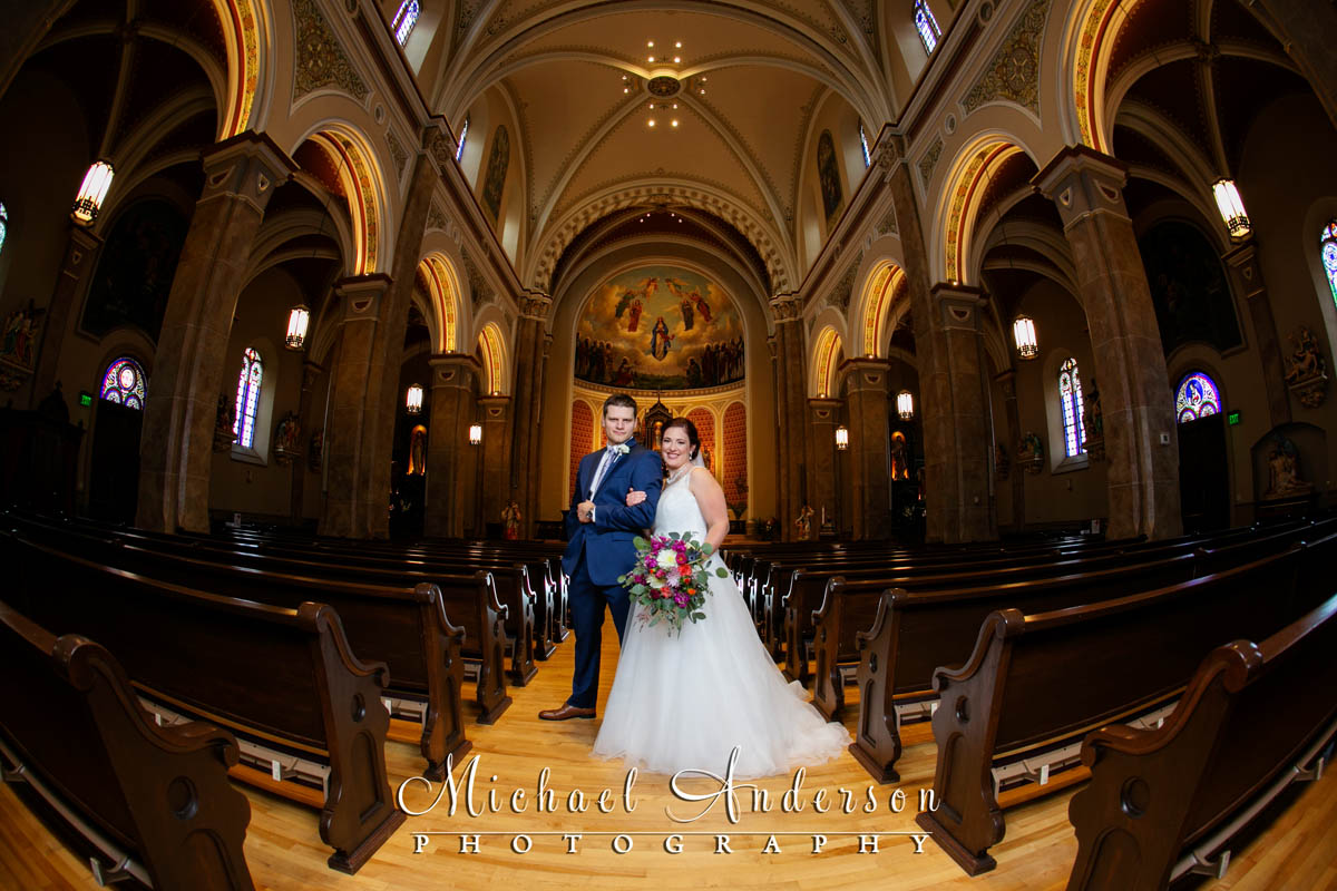 Church of the Assumption wedding photo of the bride and groom. Photo was created with a 15mm Fisheye lens.