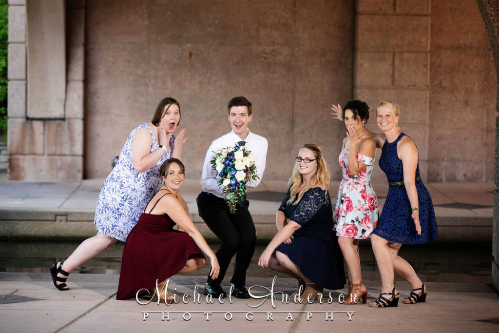 A fun Centennial Lakes wedding photo of the groom and the bridesmaids.