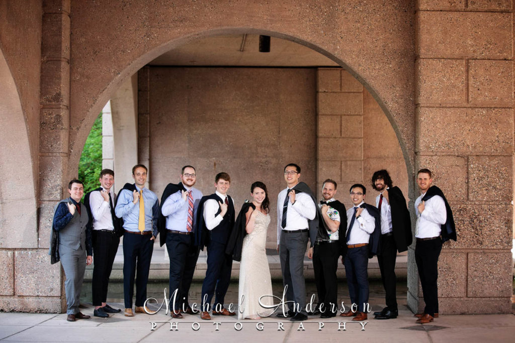 A fun Centennial Lakes wedding photo of the bride and the groomsmen.