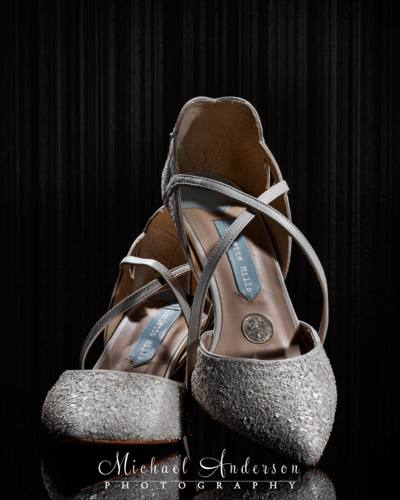 A cool light painted photo of the brides pretty wedding shoes complete with a Sixpence.