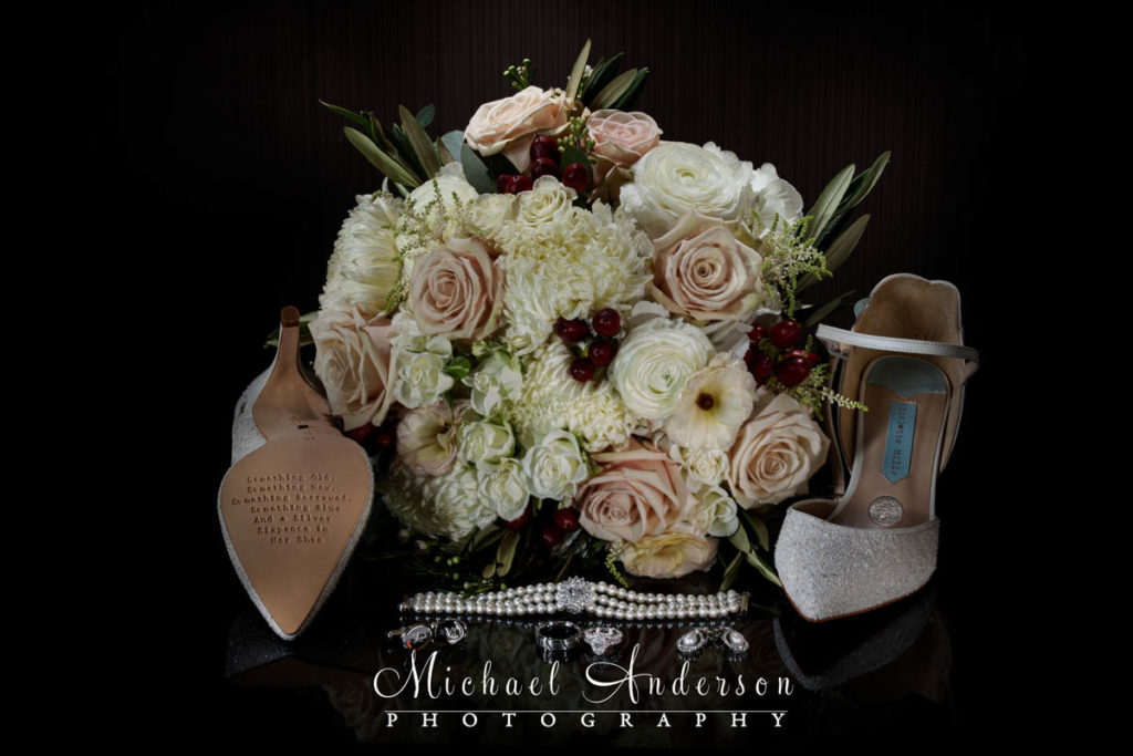 A light painted photo of the brides bouquet, shoes, and jewelry.