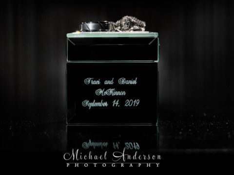 Light painted wedding photograph of the couple's wedding rings on top of their mirrored ring box.