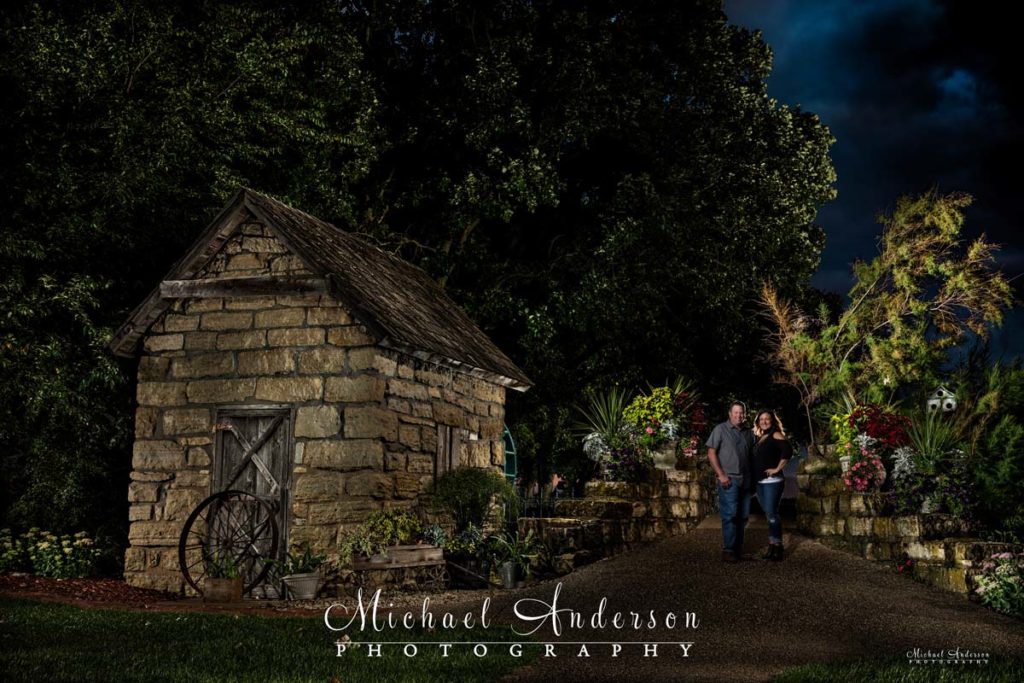 Light painted engagement photograph of a cute couple at the Old Country Grist Mill at Old Log House Pioneer Village in Hastings, MN.