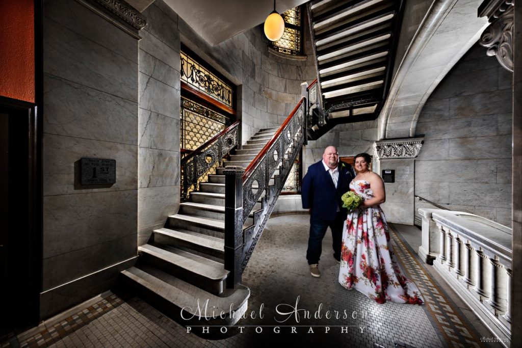 A cool Minneapolis City Hall light painting of a bride and groom by one of the cool staircases.