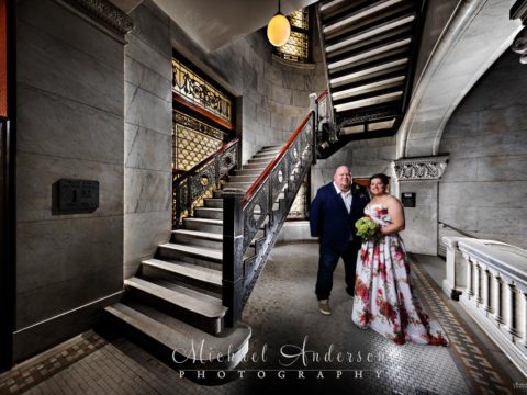 A cool Minneapolis City Hall light painting of a bride and groom by one of the cool staircases.