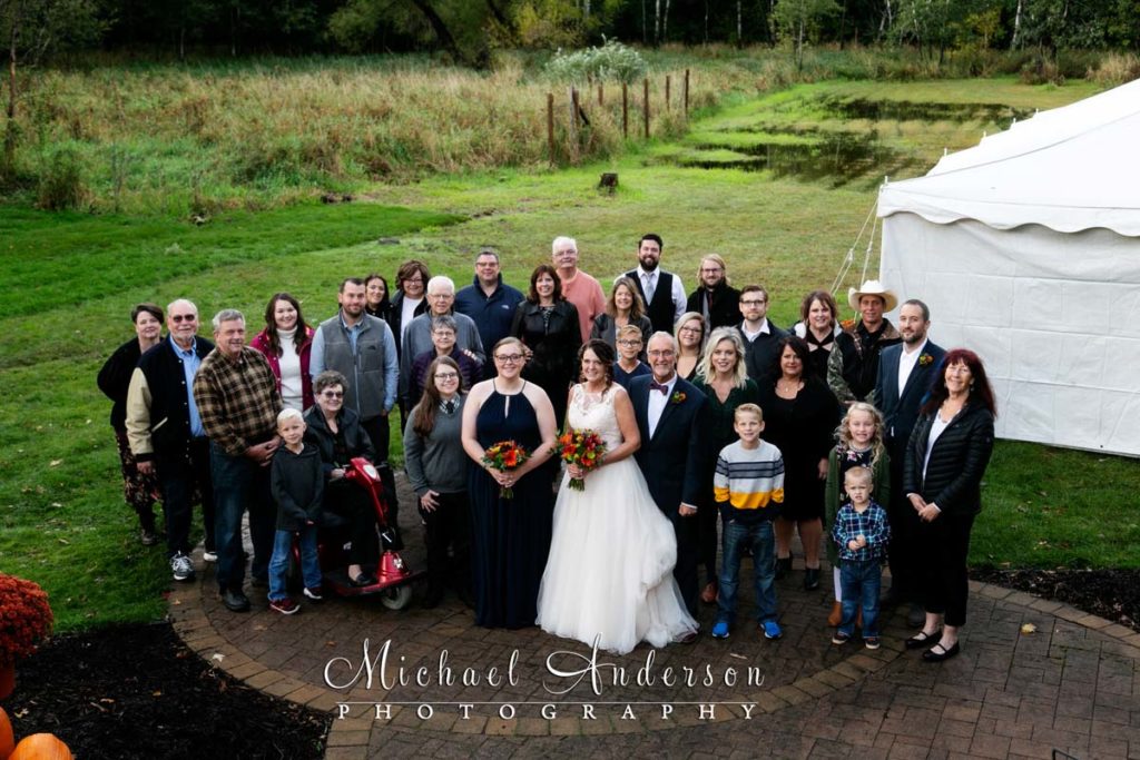 The bride, groom, and all of their wedding guests at their beautiful backyard wedding.