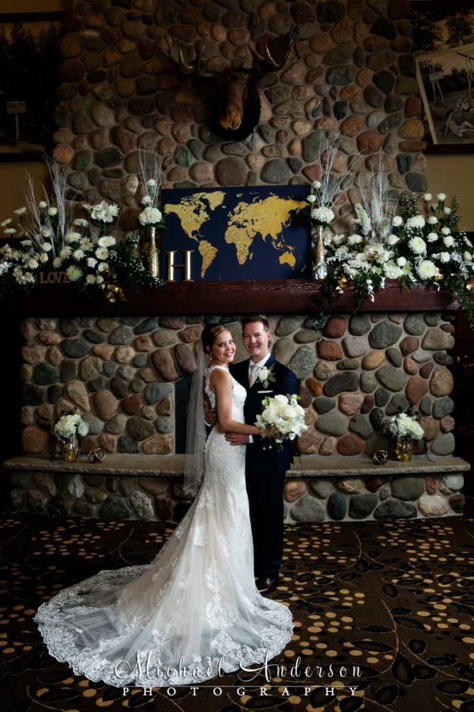 A bride and groom at the Gull Lake Center fireplace at Grandview, Lodge in Nisswa, MN.