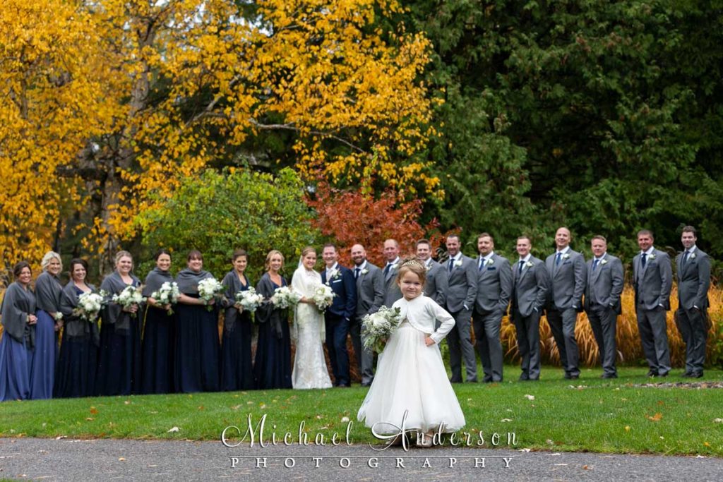The cute flower girl in front of the wedding party at Grandview Lodge in Nisswa, Minnesota.