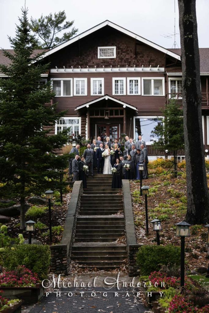 A fun wedding photo of the wedding party on the Grand Staircase at Grandview Lodge in Nisswa, MN.