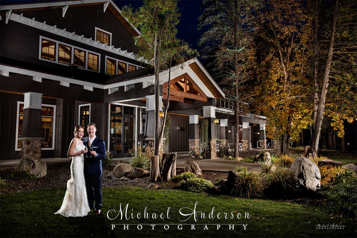 A beautiful light painted wedding photo of the bride and groom outside of The Gull Lake Center at Grandview Lodge in Nisswa, MN.