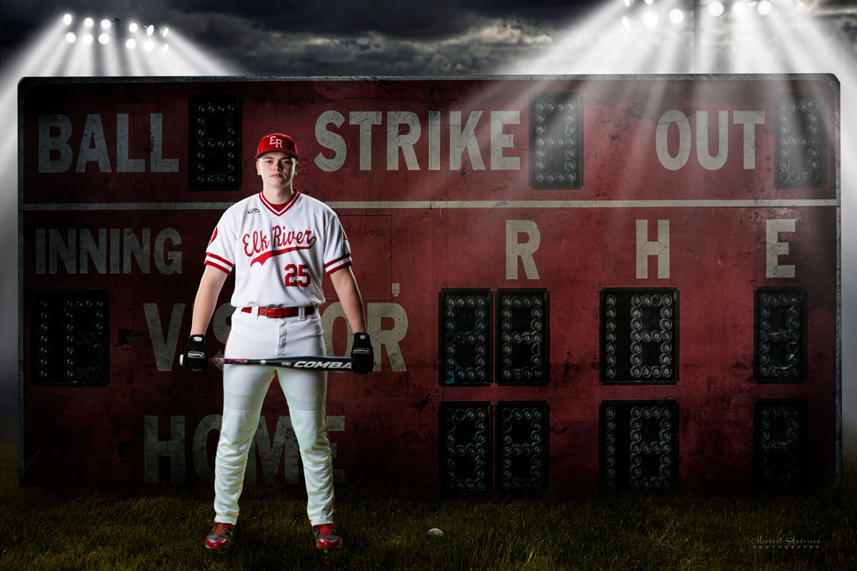 Elk River High School senior portrait green screen composite. A baseball player, with his bat, standing in front of a scoreboard.