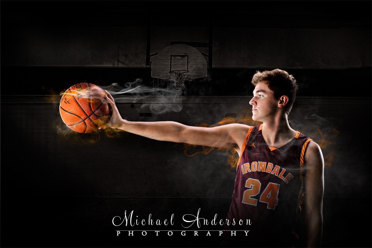 The Class of 2020 Irondale High School boys basketball photo. Senior holding a smoking basketball.