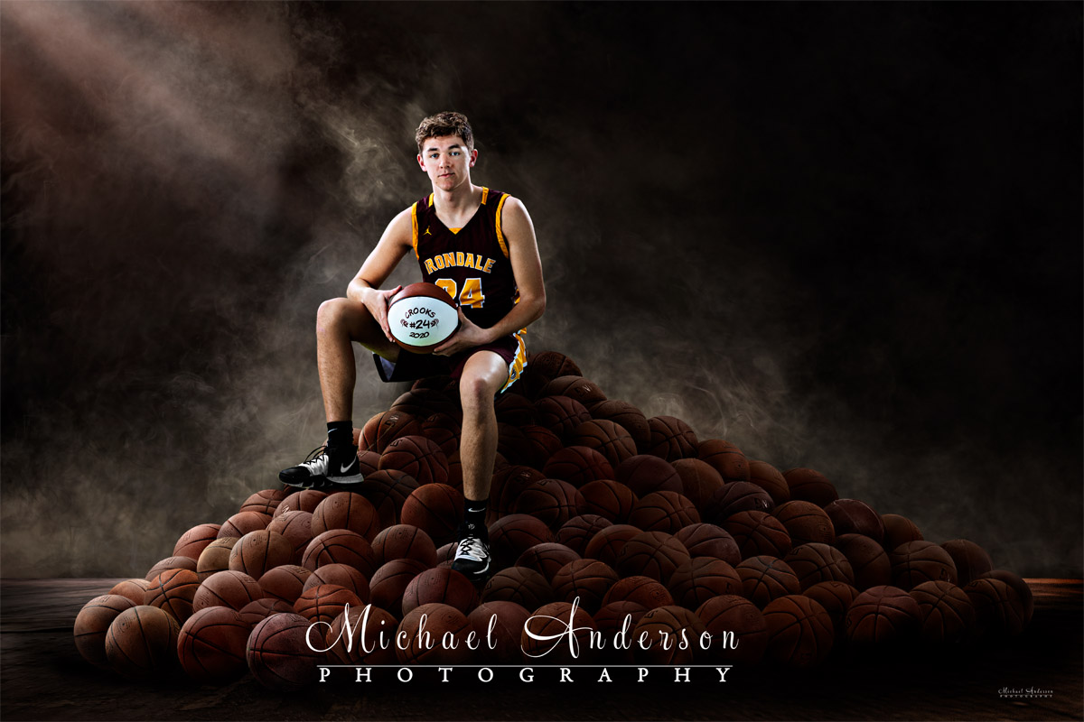 Professional senior photographer in Mounds View, Minnesota. Irondale High School boys basketball composite on a pile of basketballs.