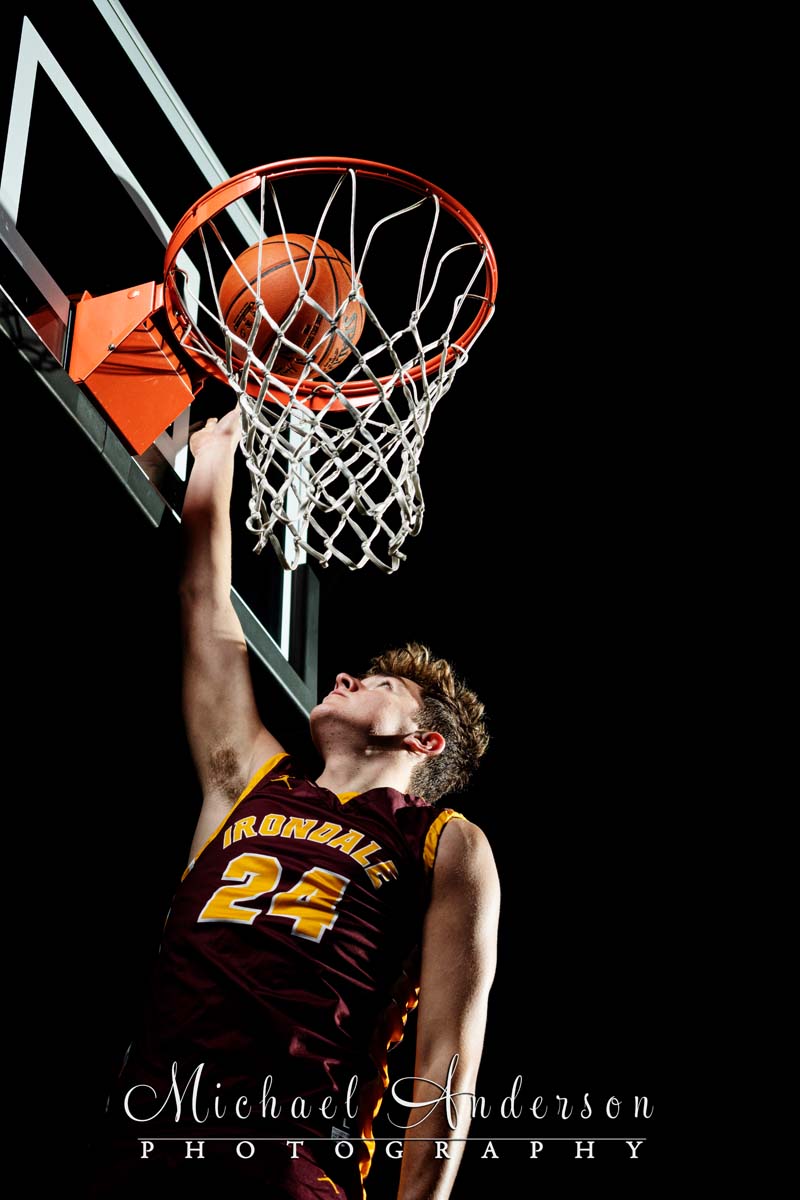 Close up of an Irondale High School senior boy shooting a basketball.