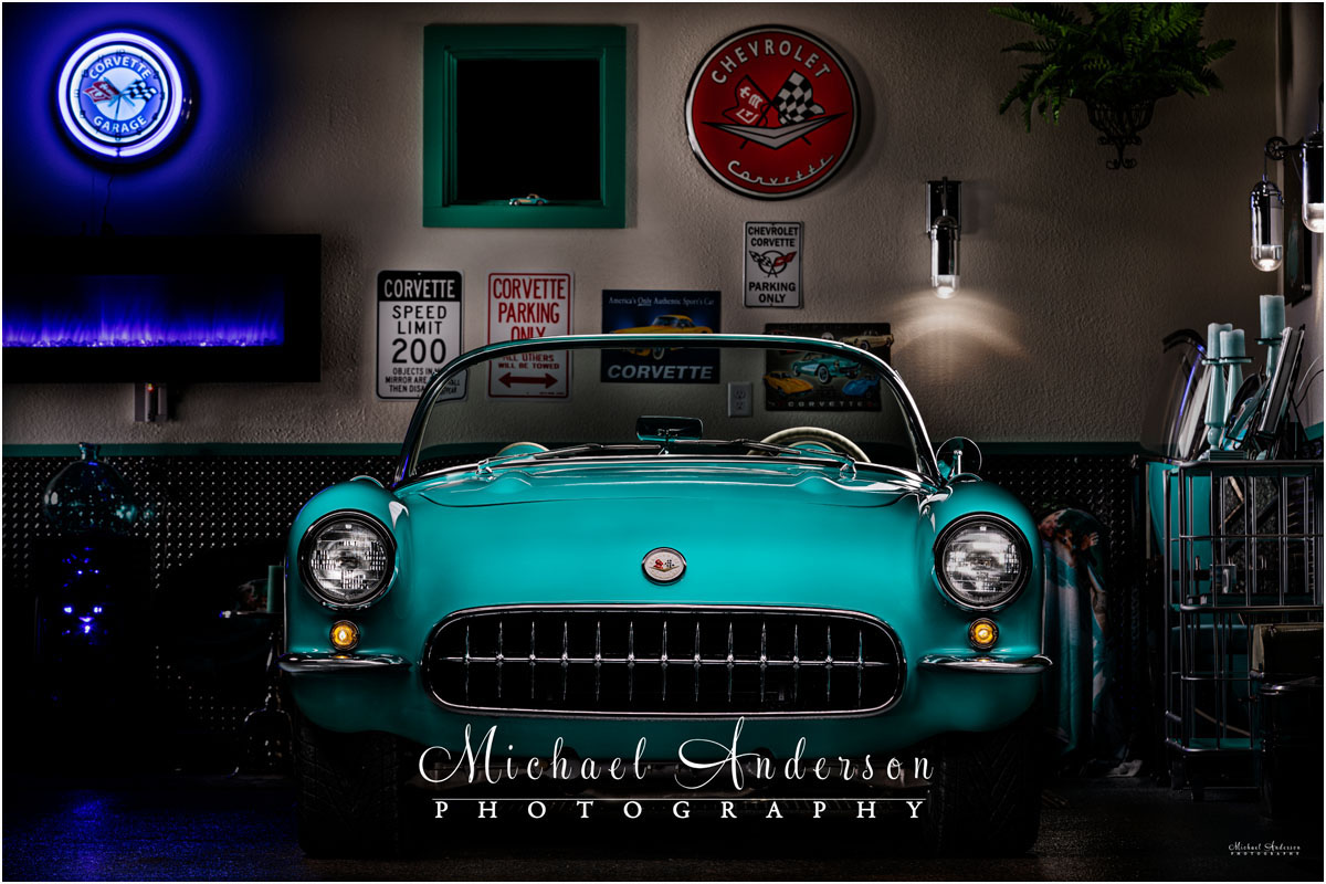 A light painting a 1957 C1 Corvette in a matching she shed.
