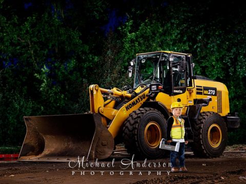 A cool light painting of a Komatsu WA270-8 and a three-year-old boy dressed as a construction worker.