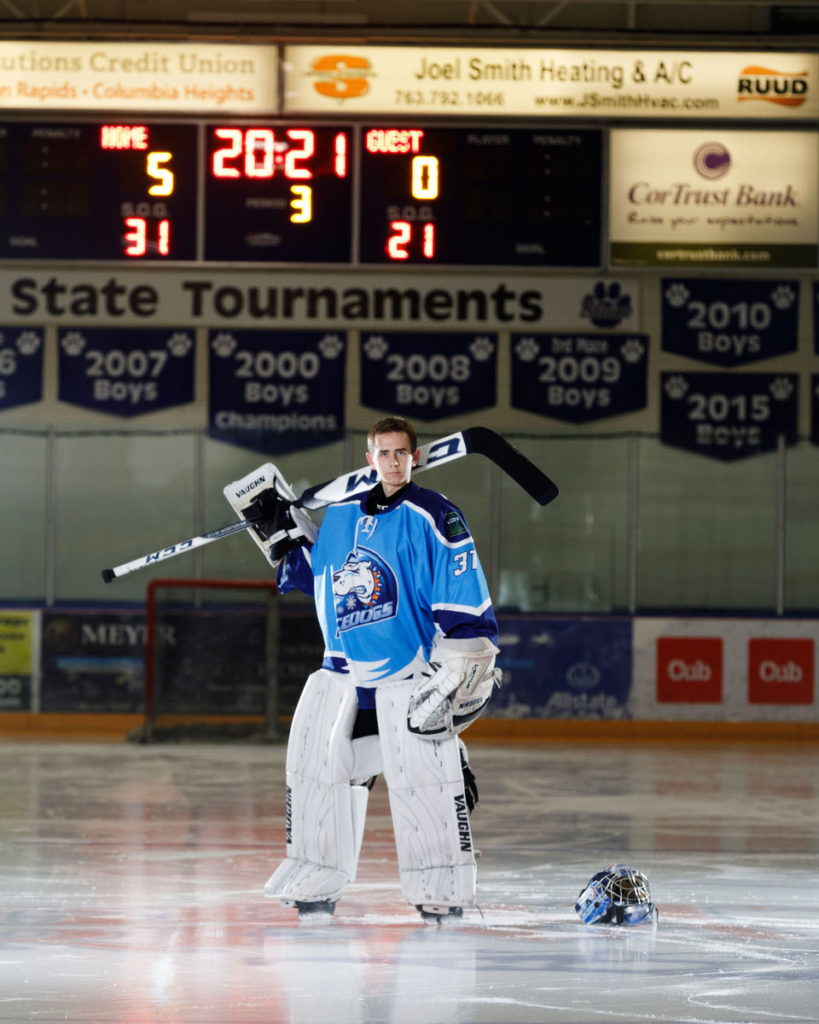 Boy-goalie-hockey-net-senior-photos-at-Fogerty-Ice-Arena